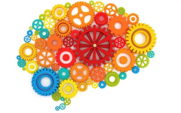 Brightly coloured, differently sized cogs forming the shape of a brain.